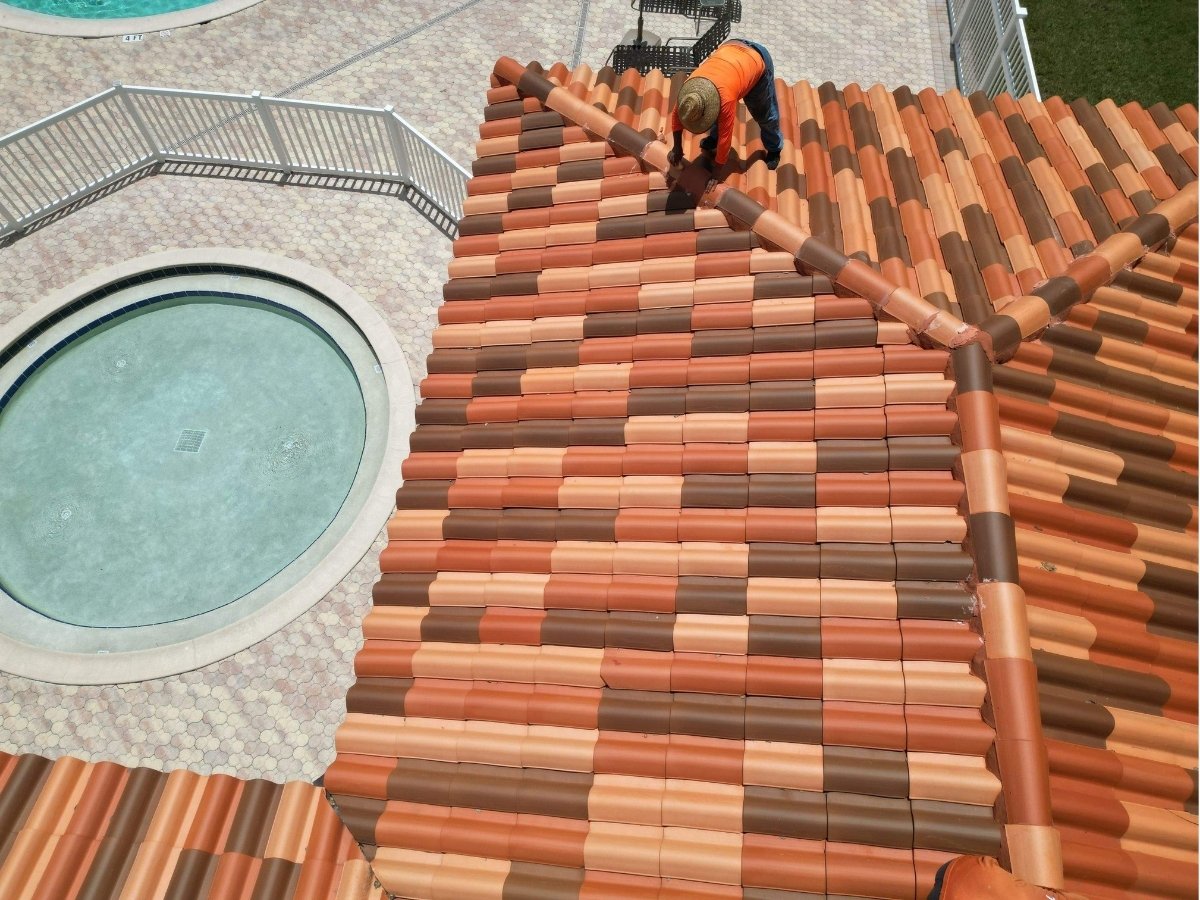 Roofing crew member working on a tile roof in Land O’ Lakes, Florida